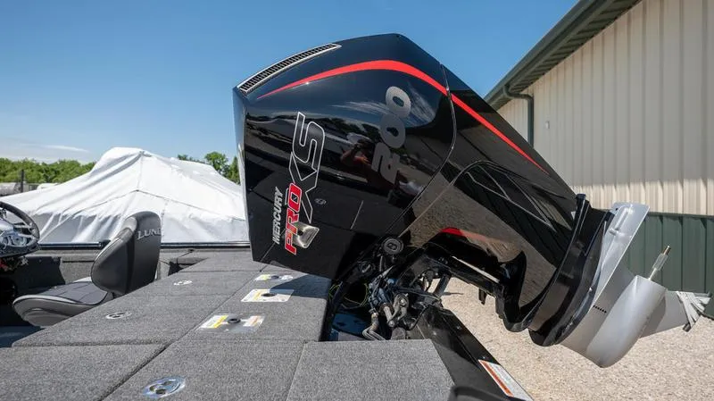Slide: The Image of 2024 Lund 1875 Pro-V Bass XS boat with powerful outboard motor. - 5
