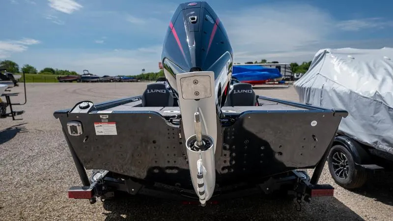 Slide: The Image of 2024 Lund 1875 Pro-V Bass XS boat rear view in a parking lot. - 6