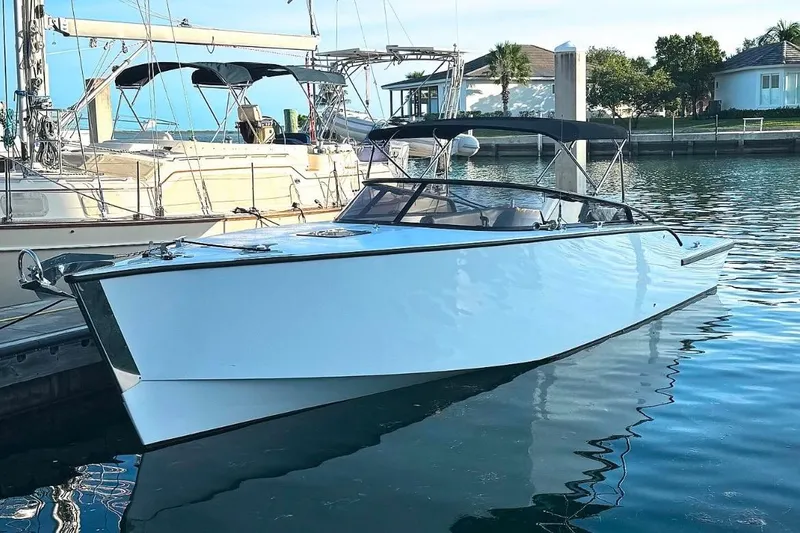 The Image of 2023 VanDutch Sport 35 yacht docked in a marina, reflecting on calm water. - 0