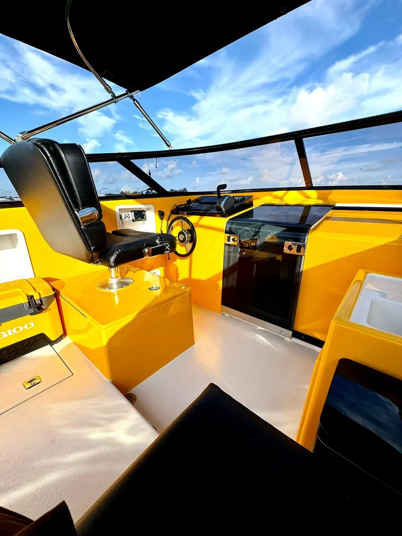 Slide: The Image of Interior of 2023 VanDutch Sport 35 yacht with yellow accents and modern controls. - 12