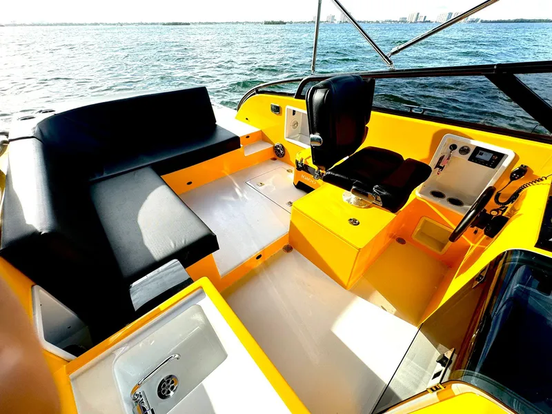 Slide: The Image of 2023 VanDutch Sport 35 boat interior with yellow accents and black seating. - 5