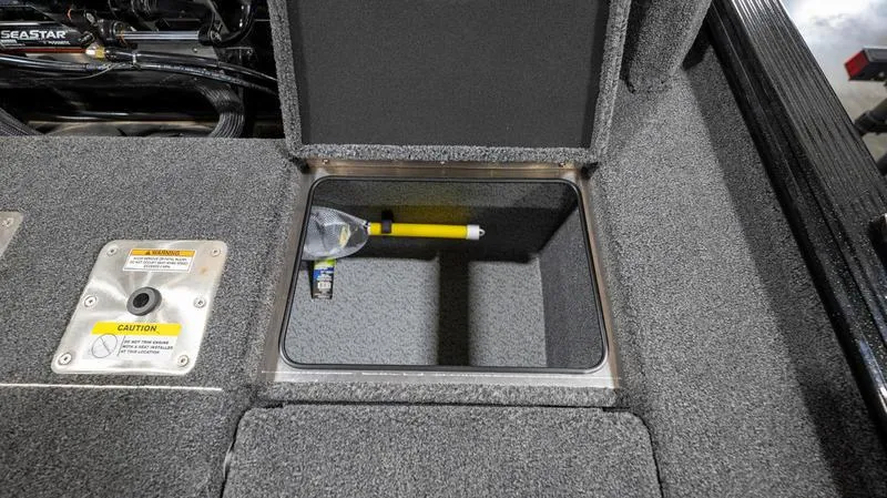 Slide: The Image of 2024 Lund 1875 Pro-V Bass XS storage compartment with safety equipment. - 13