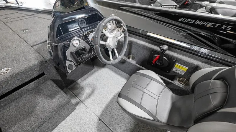 Slide: The Image of 2024 Lund 1875 Pro-V Bass XS boat interior with steering wheel and seating. - 18