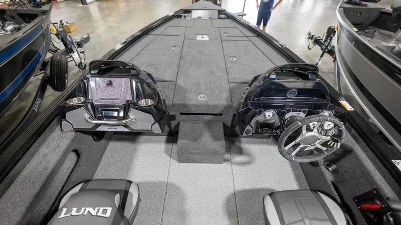 Slide: The Image of 2024 Lund 1875 Pro-V Bass XS boat interior with dual consoles and spacious deck. - 24