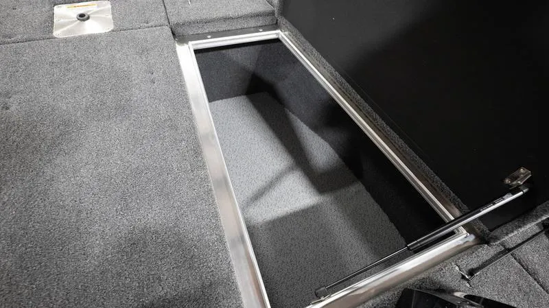 Slide: The Image of 2024 Lund 1875 Pro-V Bass XS storage compartment with carpeted interior. - 30