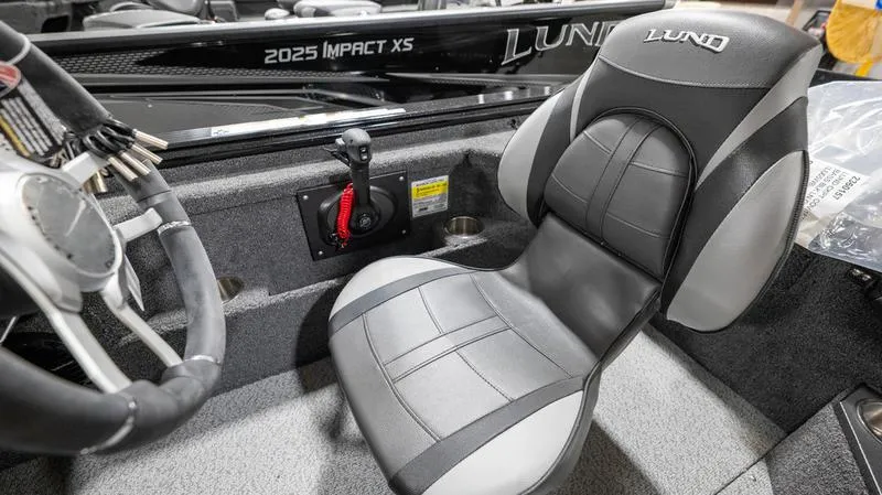 Slide: The Image of 2024 Lund 1875 Pro-V Bass XS boat interior with steering wheel and seat. - 34