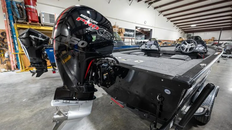 Slide: The Image of 2024 Lund 1875 Pro-V Bass XS boat with Mercury Pro XS engine in a warehouse. - 8
