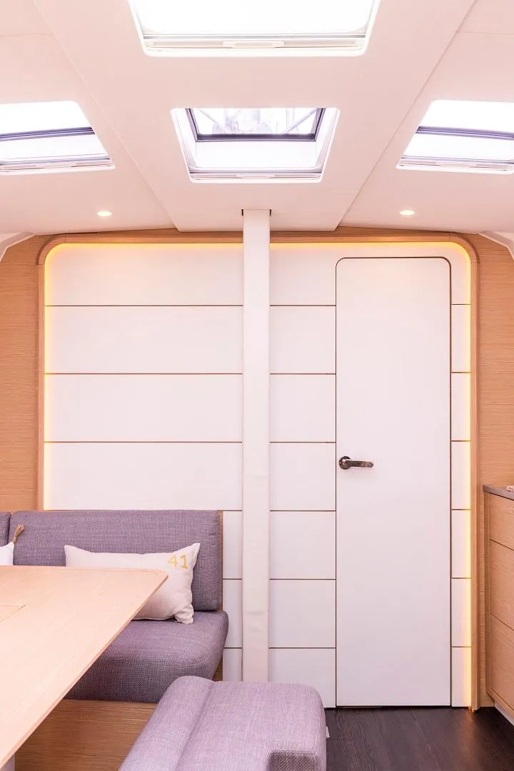 Slide: The Image of Modern interior of 2024 Dufour 41 sailboat with skylights and cozy seating. - 13