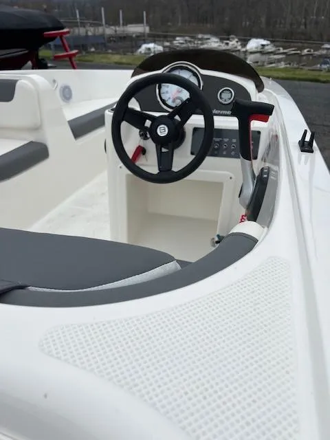 Slide: The Image of 2023 Bayliner Element E18 boat interior with steering wheel and dashboard. - 11