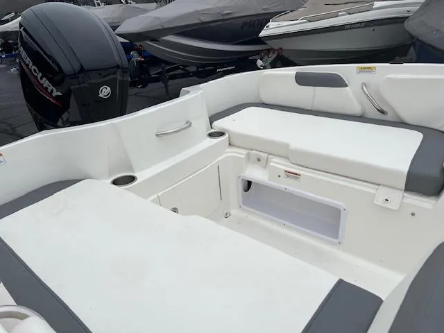 Slide: The Image of 2023 Bayliner Element E18 boat interior with seating and storage compartments. - 12