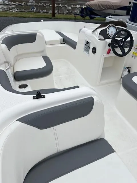 Slide: The Image of 2023 Bayliner Element E18 boat interior with gray and white seating. - 5