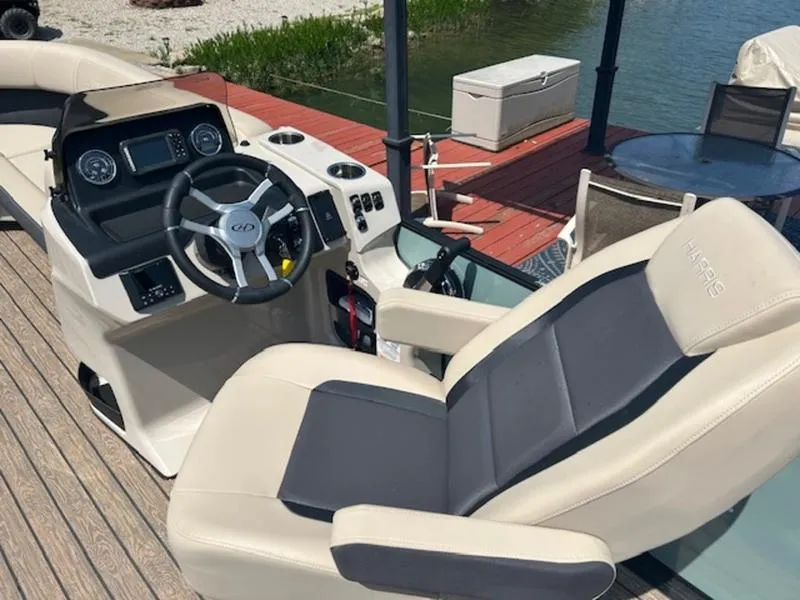 Slide: The Image of Interior of 2024 Harris Cruiser 230 SL with steering and seat. - 5