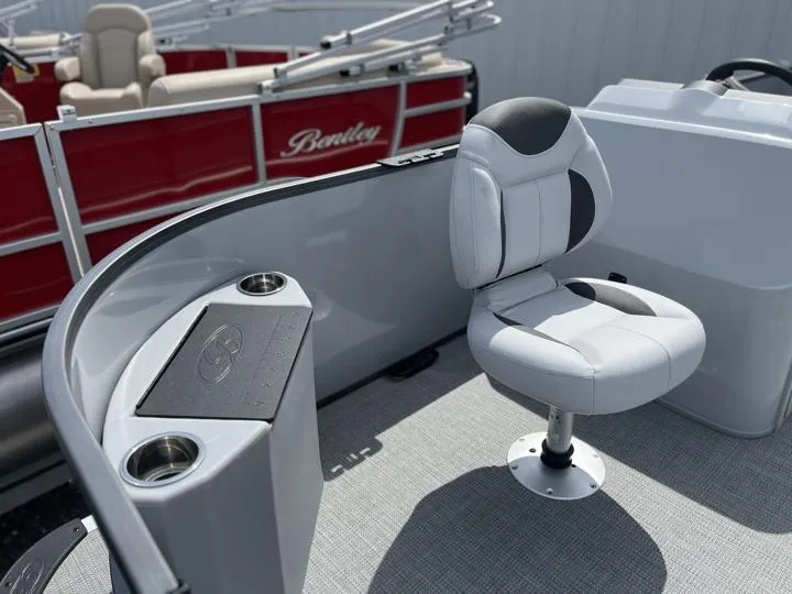 Slide: The Image of 2024 Bentley Pontoons LE 180 3 PT interior with seating and cup holders. - 10
