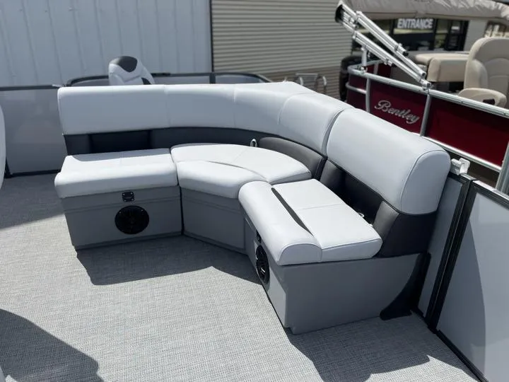 Slide: The Image of 2024 Bentley Pontoons LE 180 3 PT interior seating area with gray and white upholstery. - 12