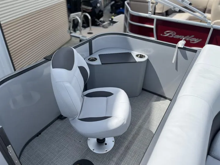 Slide: The Image of 2024 Bentley Pontoons LE 180 3 PT interior with captain's chair and console. - 13