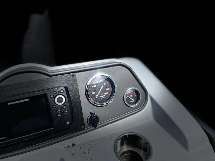 Slide: The Image of 2024 Bentley Pontoons LE 180 3 PT dashboard with gauges and controls. - 18