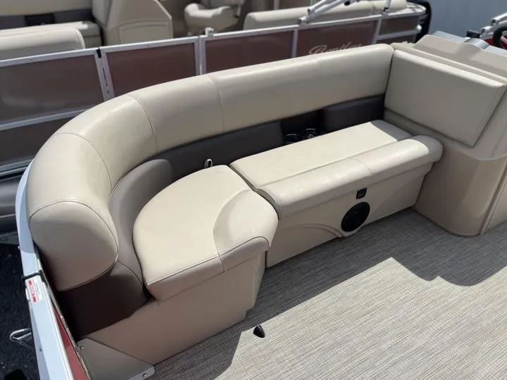 Slide: The Image of 2024 Bentley Pontoons LE 180 3 PT interior seating area with beige upholstery. - 11