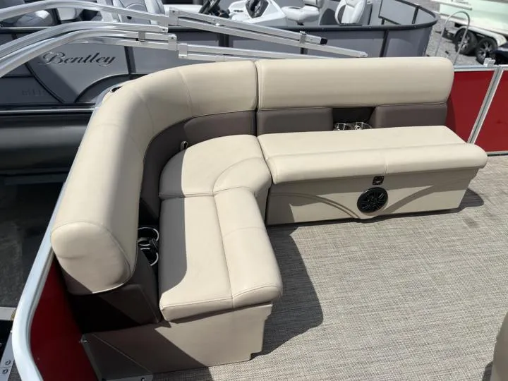 Slide: The Image of 2024 Bentley Pontoons LE 180 3 PT interior seating with beige upholstery. - 15