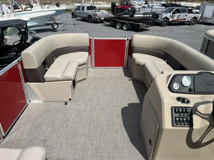 Slide: The Image of 2024 Bentley Pontoons LE 180 3 PT interior with beige seating and red accents. - 16
