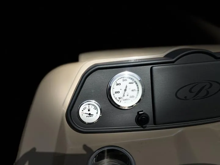 Slide: The Image of Dashboard of 2024 Bentley Pontoons LE 180 3 PT with fuel and speed gauges. - 19