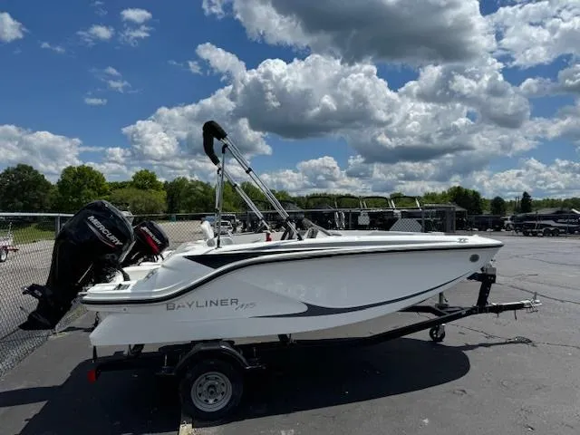Slide: The Image of 2024 Bayliner Element M15 boat on trailer under a partly cloudy sky. - 1