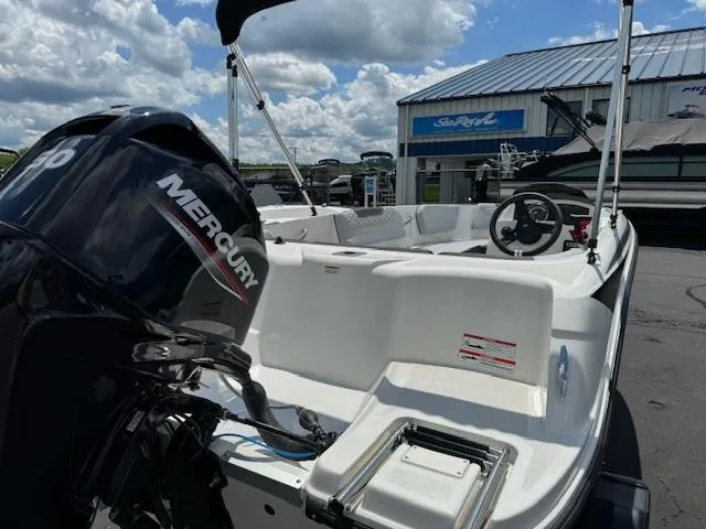 Slide: The Image of 2024 Bayliner Element M15 boat with Mercury engine at a marina. - 2