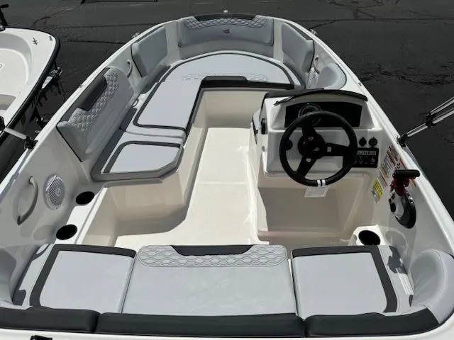 Slide: The Image of 2024 Bayliner Element M15 boat interior with seating and steering console. - 4