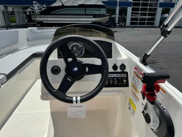Slide: The Image of 2024 Bayliner Element M15 boat dashboard and steering wheel. - 6
