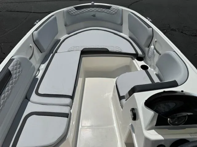 Slide: The Image of 2024 Bayliner Element M15 boat interior with cushioned seating and steering console. - 7