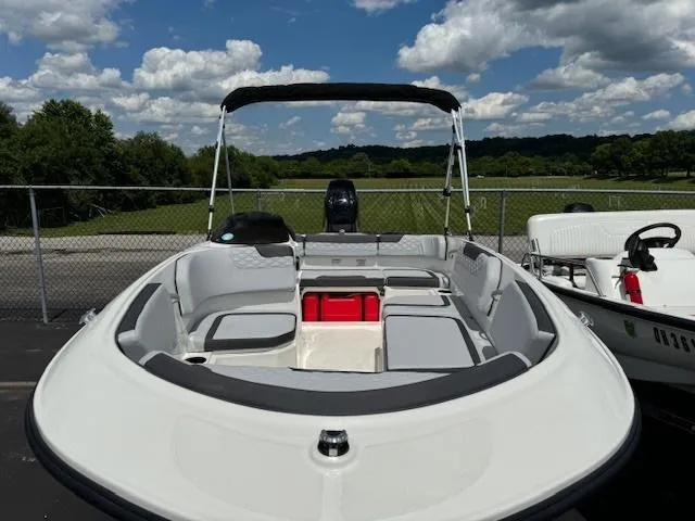 Slide: The Image of 2024 Bayliner Element M15 boat with seating and storage, parked outdoors. - 9