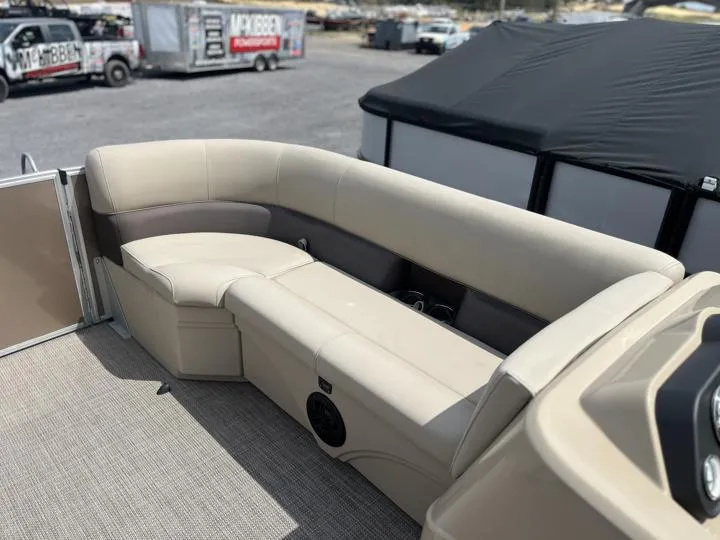 Slide: The Image of 2024 Bentley Pontoons LE 180 CR interior seating area with beige upholstery. - 16