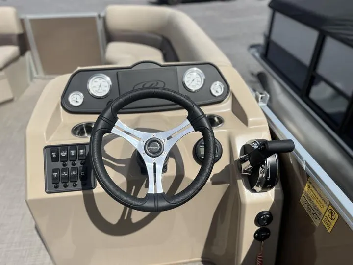 Slide: The Image of 2024 Bentley Pontoons LE 180 CR steering console with controls and gauges. - 18