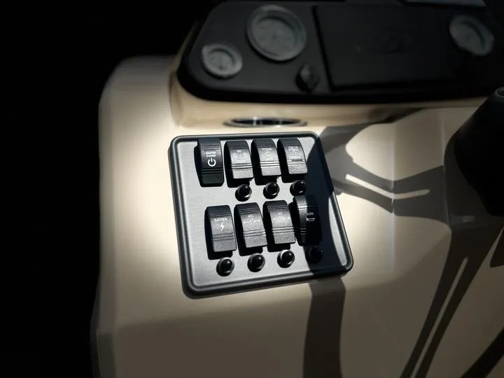 Slide: The Image of Control panel of 2024 Bentley Pontoons LE 180 CR boat with switches and gauges. - 19