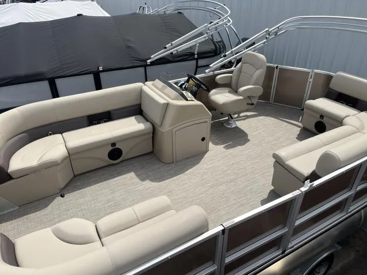 Slide: The Image of 2024 Bentley Pontoons LE 180 CR interior with beige seating and helm station. - 2
