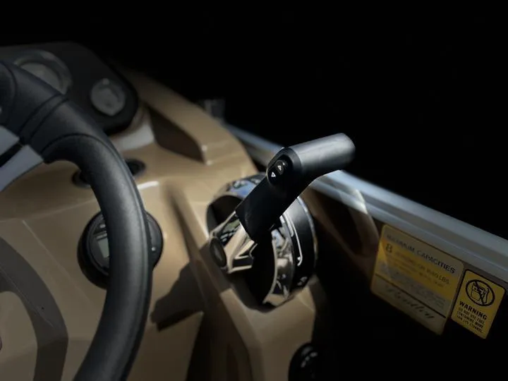 Slide: The Image of Close-up of 2024 Bentley Pontoons LE 180 CR steering wheel and throttle. - 23