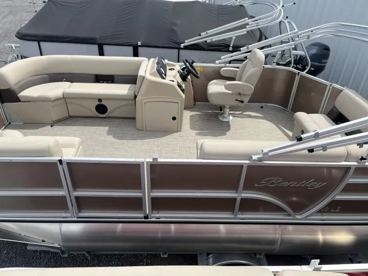 Slide: The Image of 2024 Bentley Pontoons LE 180 CR, luxury pontoon boat with beige seating and modern helm. - 3
