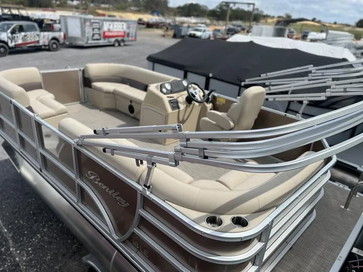Slide: The Image of 2024 Bentley Pontoons LE 180 CR, luxury pontoon boat with beige seating and modern helm. - 4