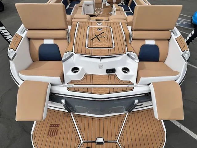 Slide: The Image of 2024 MasterCraft X24 boat interior with luxurious seating and modern design. - 10