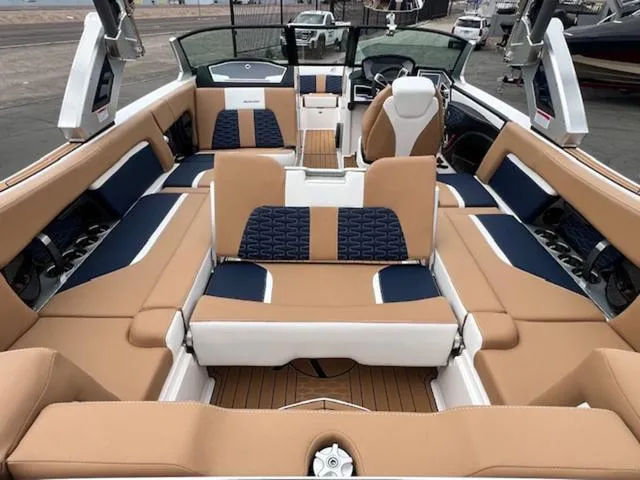 Slide: The Image of 2024 MasterCraft X24 boat cockpit with modern steering wheel and touchscreen controls. - 11