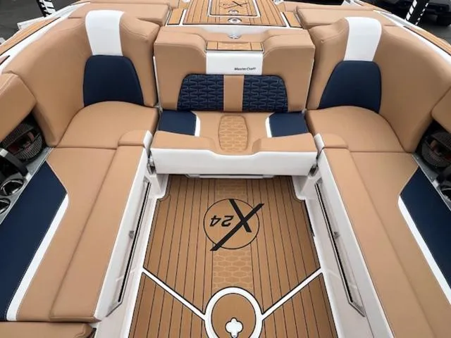 Slide: The Image of 2024 MasterCraft X24 boat interior with beige seating and modern dashboard. - 17