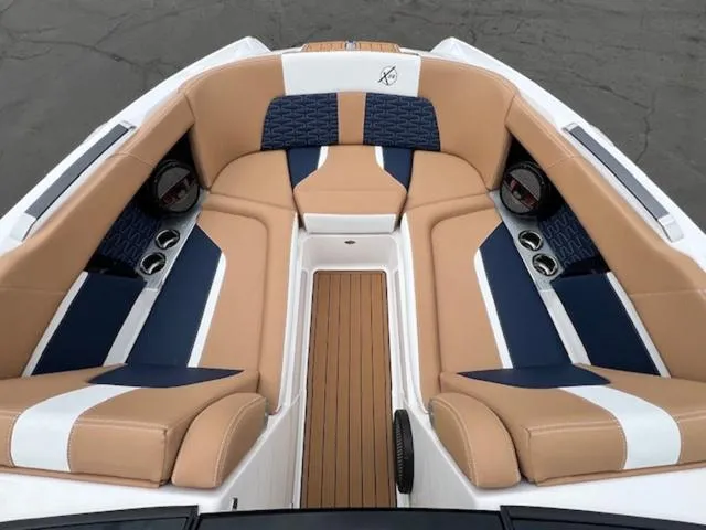 Slide: The Image of 2024 MasterCraft X24 boat on trailer with cover in dealership lot. - 20