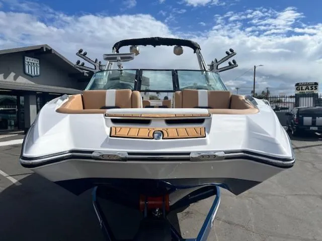Slide: The Image of 2024 MasterCraft X24 boat on trailer, front view, outdoor dealership. - 3