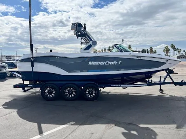 Slide: The Image of 2024 MasterCraft X24 boat on a trailer in a parking lot. - 5
