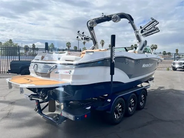 Slide: The Image of 2024 MasterCraft X24 boat rear view with wakeboard tower and swim platform. - 6
