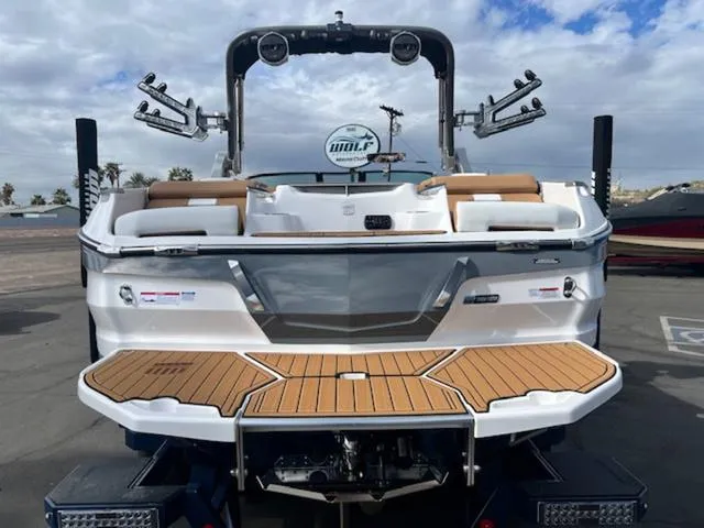Slide: The Image of 2024 MasterCraft X24 boat on trailer, rear view, in dealership lot. - 7