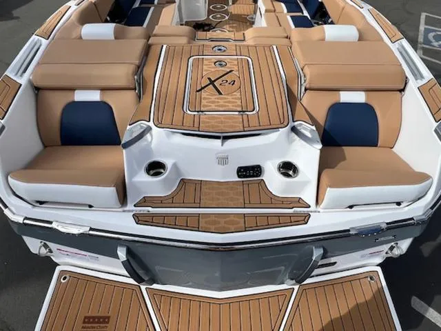 Slide: The Image of 2024 MasterCraft X24 boat interior with seating and storage compartments. - 9