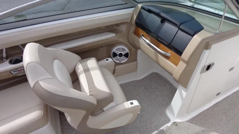 Slide: The Image of 2011 Chaparral 206 SSi boat interior with beige seating and dashboard. - 21