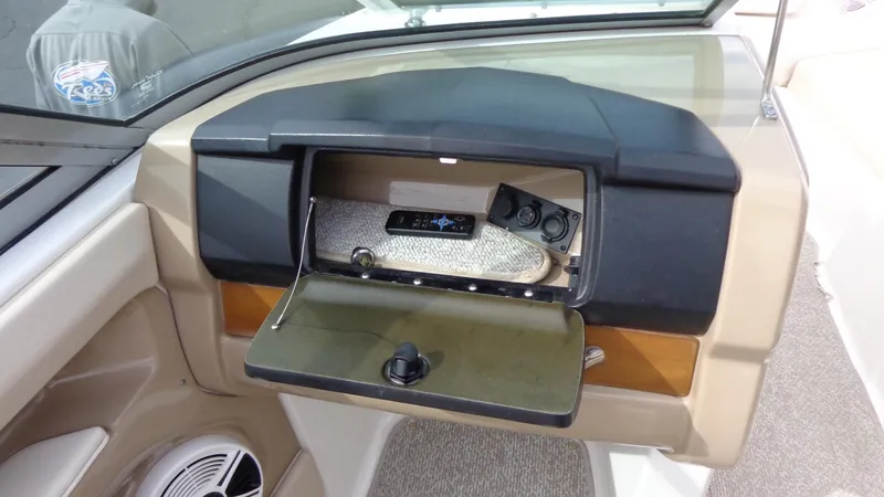 Slide: The Image of 2011 Chaparral 206 SSi boat dashboard with open glove compartment. - 22