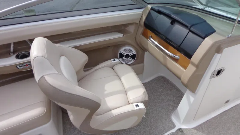 Slide: The Image of 2011 Chaparral 206 SSi boat interior with beige seating and dashboard. - 23