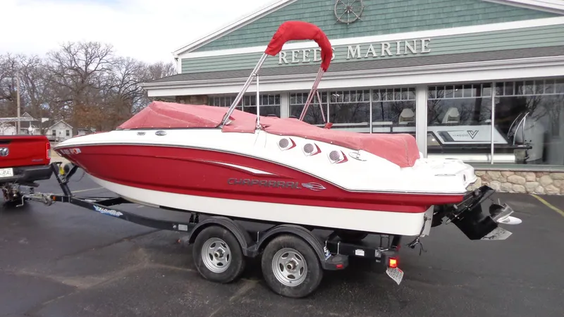 Slide: The Image of 2011 Chaparral 206 SSi boat with red cover on trailer outside Reef Marine. - 26